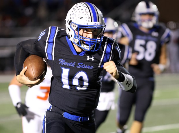 St. Charles North's QB Ethan Plumb center, runs the ball against St. Charles East during game in St. Charles on Friday, Oct. 4, 2024. (James C. Svehla / Beacon News)