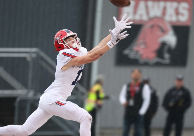 West Aurora wide receiver Reece Powers (13) catches a pass from quarterback Mason Atkins (2, not pictured) during a Class 8A second-round game at Maine South High School in Park Ridge on Saturday, Nov. 9, 2024. (Talia Sprague / Beacon News)