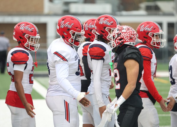 West Aurora players shake hands with Maine South players following a loss in a Class 8A second-round game at Maine South High School in Park Ridge on Saturday, Nov. 9, 2024. (Talia Sprague / Beacon News)