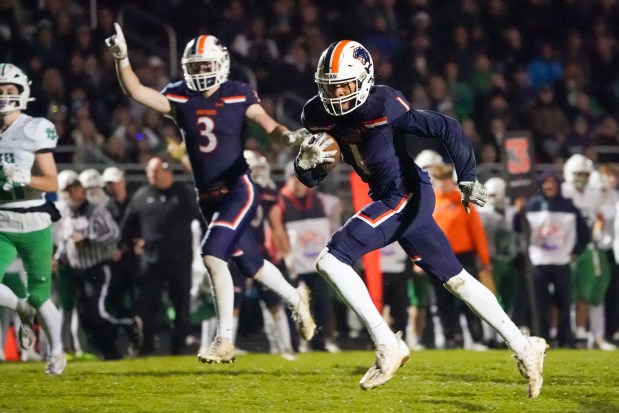 Oswego's Jeremiah Cain (1) runs after the catch for a touchdown against York during a 8A second-round football playoff game at Oswego High School on Friday, Nov 8, 2024. (Sean King / for The Beacon-News)