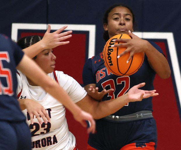 Oswego's Ahlivia East (32) steals the ball away from West Aurora's Savannah Fitzsimons (23) in the second quarter during the a West Aurora Thanksgiving Tournament game Monday, Nov. 25, 2024 in Aurora. (H. Rick Bamman / The Beacon-News)