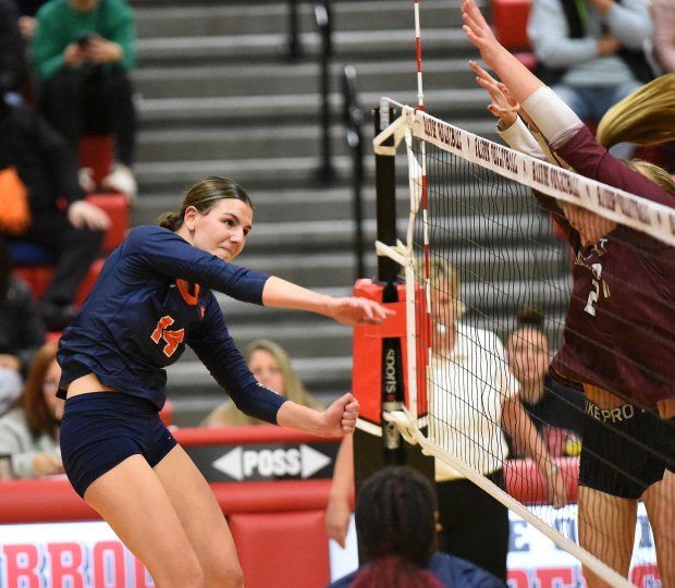 Oswego's Mia Jurkovic (14) follows through on a spike against Lockport during the Class 4A Bolingbrook Sectional final Thursday, Nov. 7, 2024 in Bolingbrook, IL. (Steve Johnston/for the The Beacon-News)