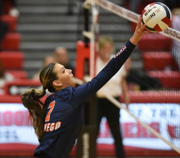 Oswego's Hannah Herrick (7) tips the ball over the net against Lockport during the Class 4A Bolingbrook Sectional final Thursday, Nov. 7, 2024 in Bolingbrook, IL. (Steve Johnston/for the The Beacon-News)