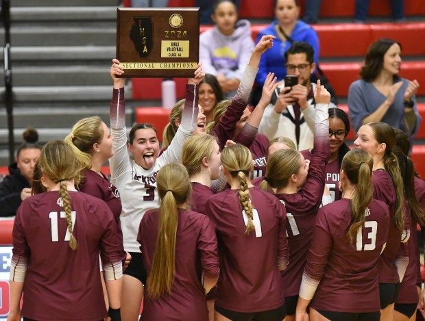 Lockport's Sadie Denk (3) holds up the Sectional Championship plaque after defeating Oswego during the Class 4A Bolingbrook Sectional final Thursday, Nov. 7, 2024 in Bolingbrook, IL. (Steve Johnston/for the The Beacon-News)