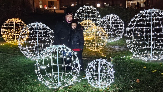 Belinda Salas of Aurora and her daughter Mariah Garcia, 6, take part in the annual Winter Lights Fest in Aurora Friday night. (David Sharos / For The Beacon-News