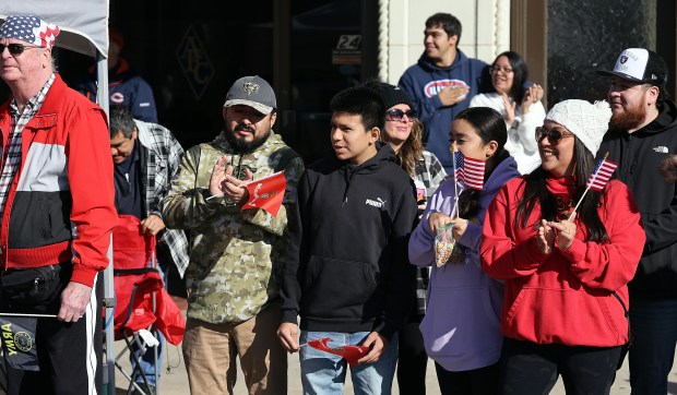 On lookers applaud along Downer Place during the Aurora Veterans Day parade on Monday, Oct. 11, 2024 in Aurora. (H. Rick Bamman / for the Beacon-News)