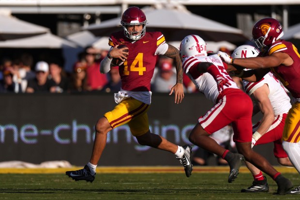 Southern California quarterback Jayden Maiava, left, tries to get past Nebraska defensive back Ceyair Wright during the second half of an NCAA college football game, Saturday, Nov. 16, 2024, in Los Angeles. (AP Photo/Mark J. Terrill)