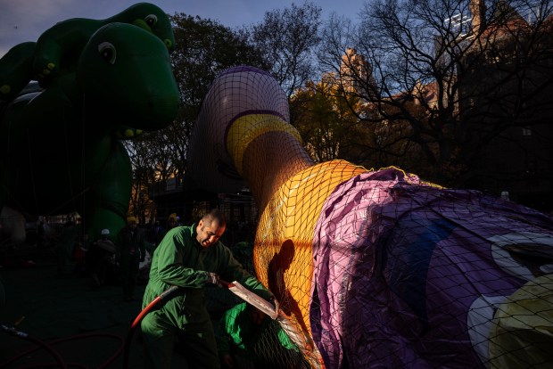 A person inflates a float in preparation for the Macy's Thanksgiving Day Parade, Wednesday, Nov. 27, 2024, in New York. (AP Photo/Yuki Iwamura)