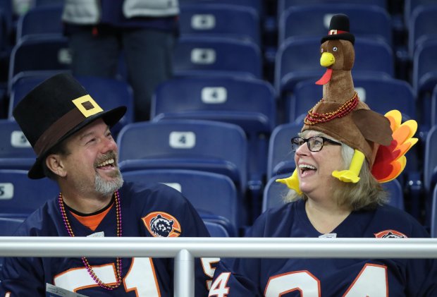 Bears fans Jim and Patti Cryer, of Plainfield, wear Thanksgiving-themed hats before a game in Detroit.