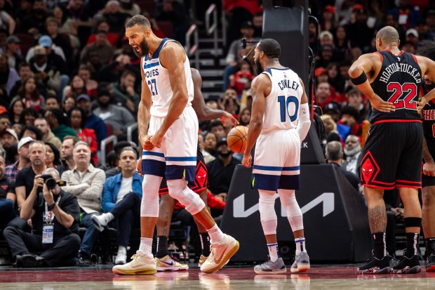 Minnesota Timberwolves center Rudy Gobert (27), left, celebrates after scoring a basket during the fourth quarter at the United Center on Nov. 7, 2024. (Tess Crowley/Chicago Tribune)