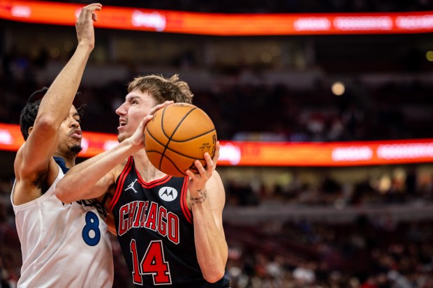 Bulls forward Matas Buzelis (14) battles Timberwolves forward Josh Minott during the fourth quarter on Nov. 7, 2024, at the United Center. (Tess Crowley/Chicago Tribune)