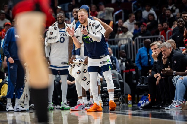 Minnesota Timberwolves guard Donte DiVincenzo (0), center, celebrates after the Timberwolves take the lead against the Chicago Bulls during the fourth quarter at the United Center on Nov. 7, 2024. The Chicago Bulls lost 135-119 against the Minnesota Timberwolves. (Tess Crowley/Chicago Tribune)