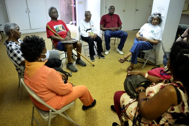 A group of Chatham Park Village Cooperative residents gather to talk about their complaints about the property during an interview with the Tribune on Aug. 17, 2023. (Chris Sweda/Chicago Tribune)