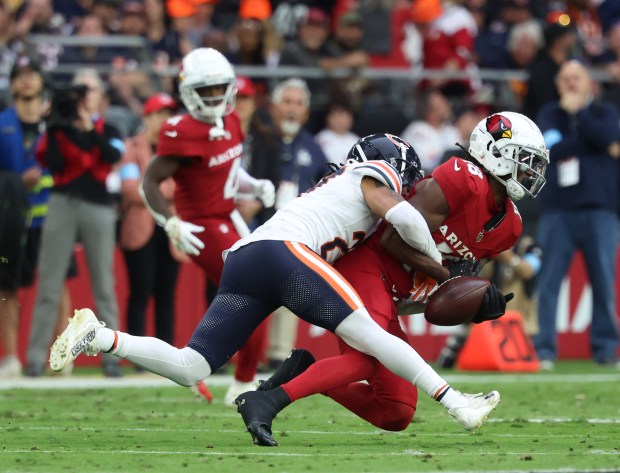 Bears cornerback Reddy Steward (27) strips the ball from Arizona Cardinals wide receiver Marvin Harrison Jr. (18) during the second quarter at State Farm Stadium on Nov. 3, 2024, in Glendale, Arizona. The Bears lost 29-9. (Stacey Wescott/Chicago Tribune)