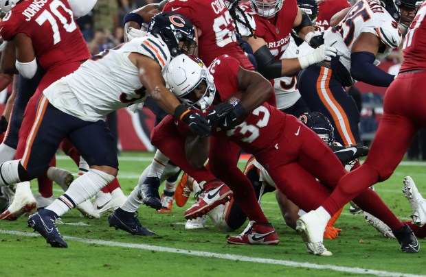 Arizona Cardinals running back Trey Benson (33) drives through Chicago Bears linebacker T.J. Edwards (53) to score a touchdown in the second quarter Sunday, Nov. 3, 2024, at State Farm Stadium in Glendale, Arizona. (Brian Cassella/Chicago Tribune)