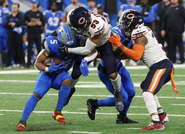 Lions running back David Montgomery (5) is tackled by Bears linebacker T.J. Edwards (53) in the fourth quarter at Ford Field on Nov. 28, 2024, in Detroit. (John J. Kim/Chicago Tribune)