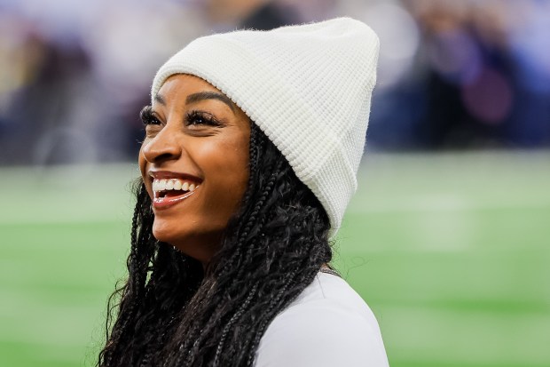 Simone Biles talks on the sidelines before the Bears play against the Lions at Ford Field in Detroit on Nov. 28, 2024. (Tess Crowley/Chicago Tribune)