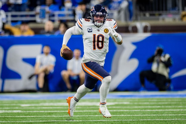 Bears quarterback Caleb Williams runs down the field during the second quarter against the Lions at Ford Field in Detroit on Nov. 28, 2024. (Tess Crowley/Chicago Tribune)