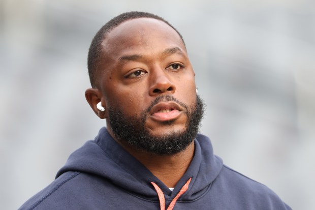 Bears offensive coordinator Thomas Brown walks the perimeter of the field before a game against the Packers at Soldier Field. (John J. Kim/Chicago Tribune)