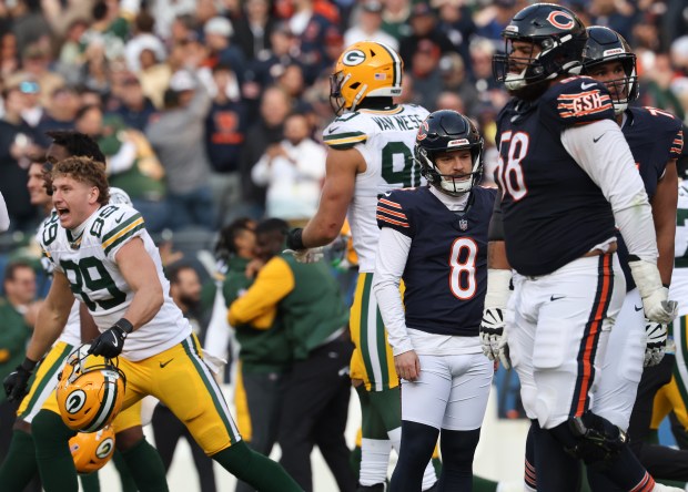 Packers players celebrate as Bears kicker Cairo Santos (8) stands alone after a 46-yard field-goal attempt was blocked as time expired on Nov. 17, 2024, at Soldier Field. (John J. Kim/Chicago Tribune)