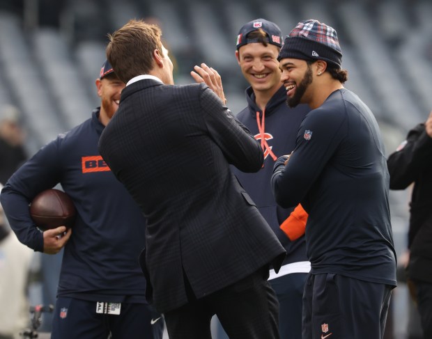 Bears quarterback Caleb Williams, right, laughs while talking with former NFL quarterback Tom Brady before a game against the Packers on Nov. 17, 2024. (John J. Kim/Chicago Tribune)