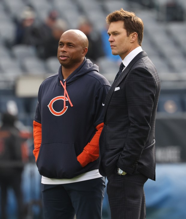 Bears quarterbacks coach Kerry Joseph, left, talks with former NFL quarterback Tom Brady at Soldier Field on Nov. 17, 2024. (John J. Kim/Chicago Tribune)