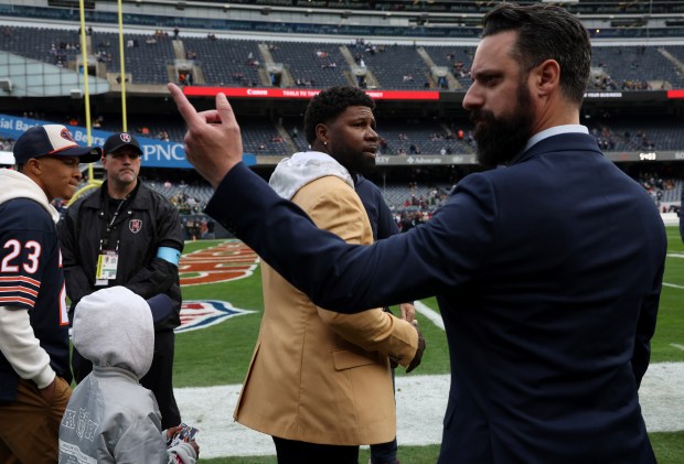 Former Bears player Devin Hester, center, arrives before a game against the Packers at Soldier Field on Nov. 17, 2024. (John J. Kim/Chicago Tribune)