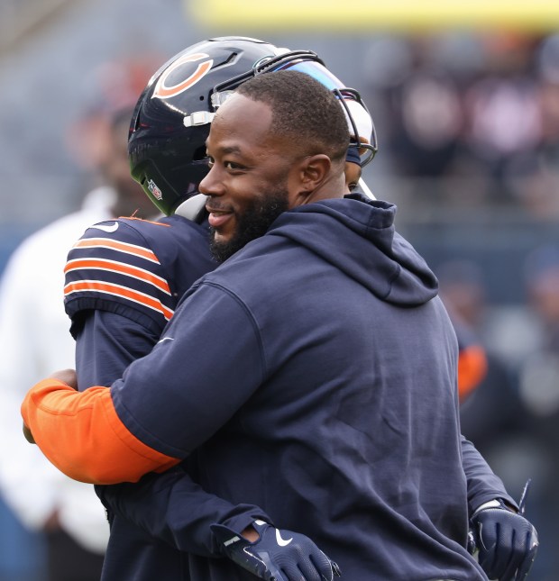 Bears offensive coordinator Thomas Brown hugs wide receiver DeAndre Carter before a game against the Packers. (John J. Kim/Chicago Tribune)