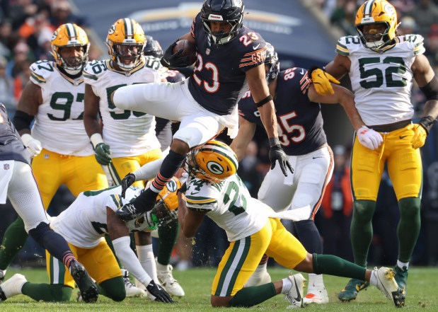 Bears running back Roschon Johnson (23) leaps over Packers cornerback Carrington Valentine (24) in the third quarter at Soldier Field on Nov. 17, 2024, in Chicago. (John J. Kim/Chicago Tribune)