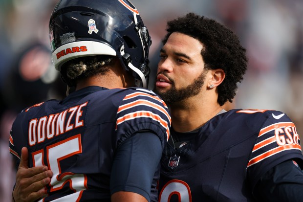 Chicago Bears quarterback Caleb Williams hugs wide receiver Rome Odunze (15) before the game against the New England Patriots. (Eileen T. Meslar/Chicago Tribune)