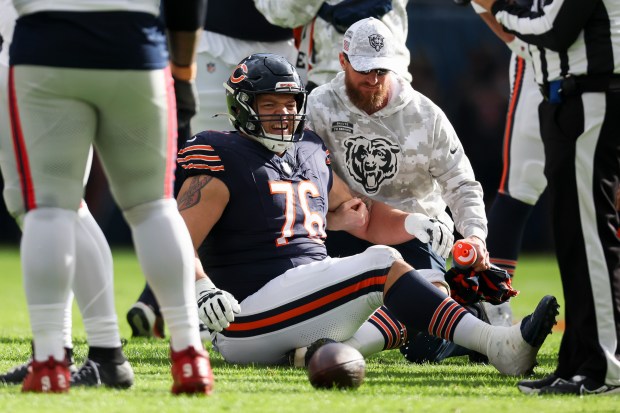 Chicago Bears guard Teven Jenkins (76) is checked out by medical personnel during the second quarter against the New England Patriots at Soldier Field on Nov. 10, 2024. (Eileen T. Meslar/Chicago Tribune)