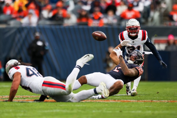 New England Patriots linebacker Jahlani Tavai (48) breaks up a pass to Chicago Bears wide receiver DJ Moore (2) during the third quarter at Soldier Field on Nov. 10, 2024. (Eileen T. Meslar/Chicago Tribune)