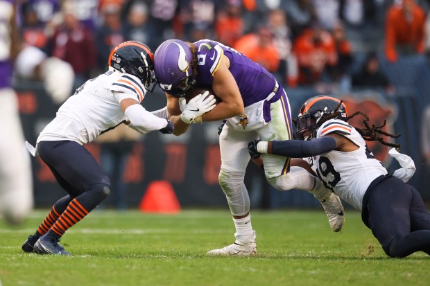 Bears cornerback Kyler Gordon and linebacker Tremaine Edmunds tackle Vikings tight end T.J. Hockenson in overtime on Nov. 24, 2024. (Eileen T. Meslar/Chicago Tribune)