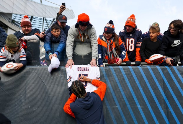 Chicago Bears wide receiver Rome Odunze (15) autographs a jersey before the game against the Minnesota Vikings at Soldier Field on Nov. 24, 2024. (Eileen T. Meslar/Chicago Tribune)