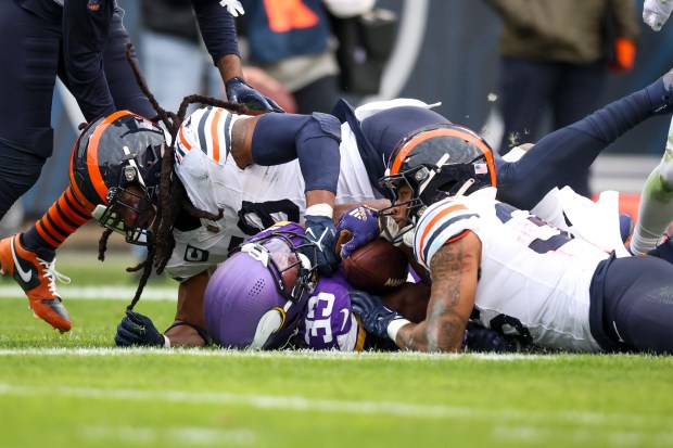 Bears linebacker Tremaine Edmunds and safety Jonathan Owens tackle Vikings running back Aaron Jones during the third quarter at Soldier Field on Nov. 24, 2024. (Eileen T. Meslar/Chicago Tribune)