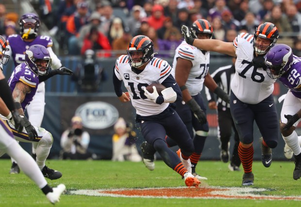 Bears quarterback Caleb Williams runs for a first down in the 4th quarter against the Vikings at Soldier Field on Nov. 24, 2024. (Stacey Wescott/ Chicago Tribune)