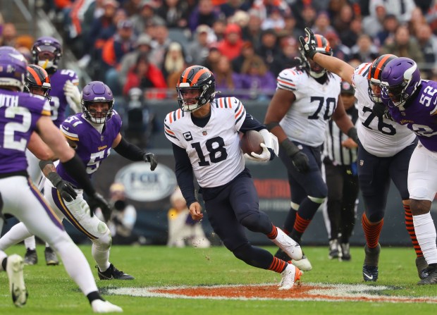 Chicago Bears quarterback Caleb Williams (18) runs for a first down in the 4th quarter during a game against the Minnesota Vikings at Soldier Field on Nov. 24, 2024 in Chicago. The Vikings beat the Bears in overtime 30-27. (Stacey Wescott/ Chicago Tribune)