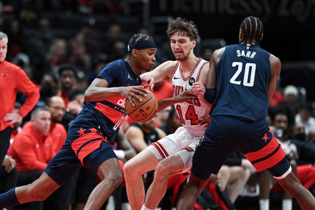 Wizards guard Bilal Coulibaly handles the ball as Bulls forward Matas Buzelis fights through a pick set by forward Alexandre Sarr during the first half Tuesday, Nov. 26, 2024, in Washington. (AP Photo/Terrance Williams)