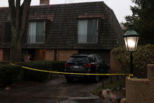 Yellow police tape stretches across a driveway at a home in the 400 block of West Russell Street in Barrington on Nov. 18, 2024. Dr. Olga Duchon, 42, was killed inside the townhome. (Stacey Wescott/ Chicago Tribune)