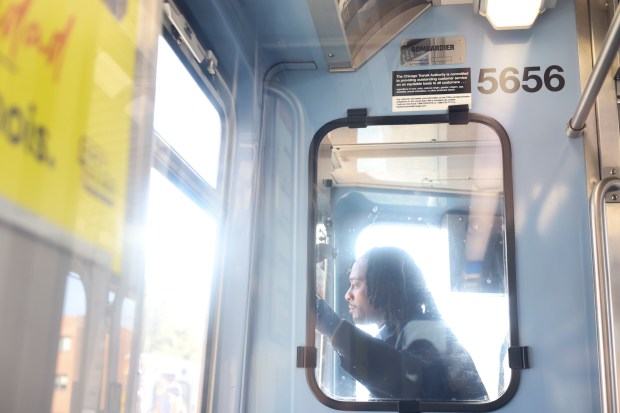 A train operator looks out the window for passengers at the Morse CTA Red Line station on Oct. 29, 2024. (Eileen T. Meslar/Chicago Tribune)