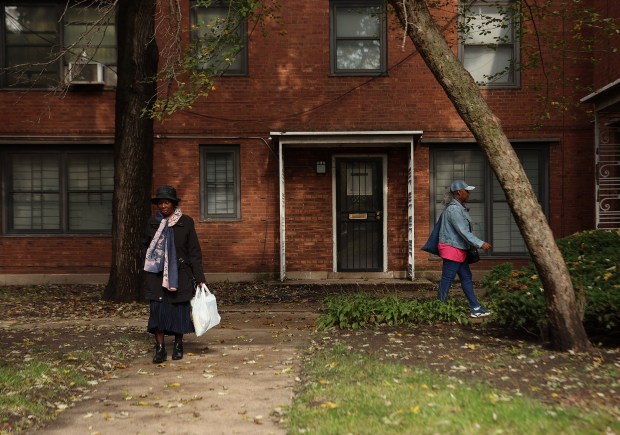 Louise Goodloe, left, and Shirley Washington, right, head back to their homes in the Chatham Park Village Cooperative on Oct. 25, 2024, in Chicago. Both women would like to see management invest more money in fixing up the community. (Stacey Wescott/Chicago Tribune)