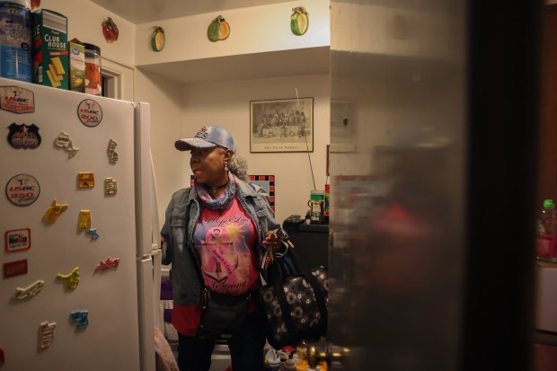 Peggy Washington heads out of her apartment in the Chatham Park Village Cooperative on Oct. 25, 2024, in Chicago. She would like to see management invest more money in fixing up their housing community. (Stacey Wescott/Chicago Tribune)