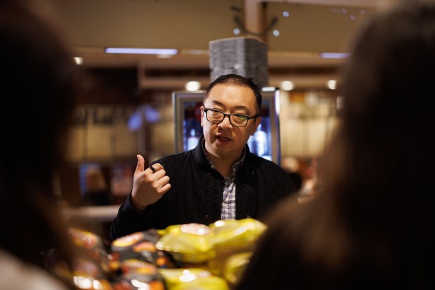 Kevin Pang, center, talks with Hannah Lindvall, left, and Julia Warsecke, right, while filming a segment for a new NBC food show show. (Armando L. Sanchez/Chicago Tribune)