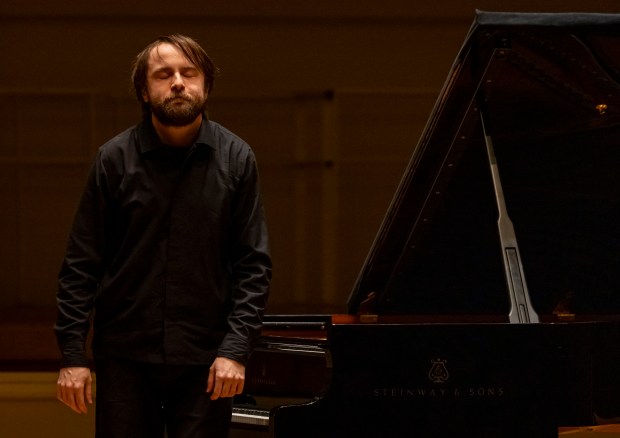 Daniil Trifonov, the Chicago Symphony Orchestra's artist-in-residence, takes a bow while playing a recital of Tchaikovsky, Chopin and Barber on Sunday, Nov. 17, 2024, at Symphony Center. (Brian Cassella/Chicago Tribune)