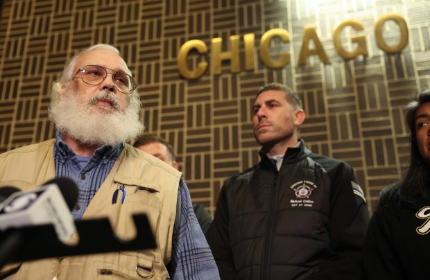 George Barzydlo, a spokesman for the family of Chicago police Officer Enrique Martinez, left, addresses reporters outside the 8th District police station at 3420 W. 63rd St. on Nov. 15, 2024. (John J. Kim/Chicago Tribune)