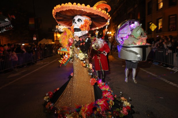 A person dressed as a Day of the Dead La Calavera Catrina marches during the Haunted Halsted Halloween Parade in the 3200 block of North Halsted Street, Oct. 31, 2024, in Chicago. (John J. Kim/Chicago Tribune)