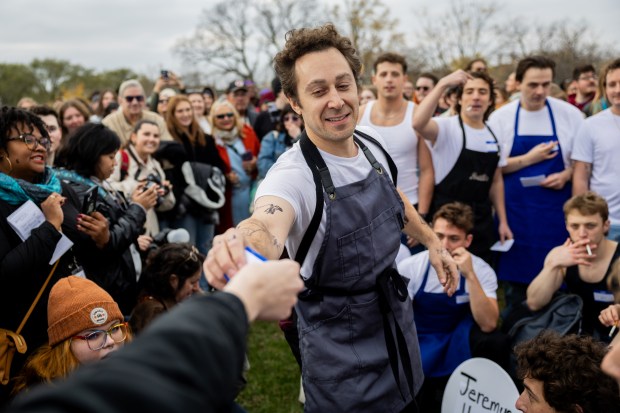 A participant takes a number at a Jeremy Allen White lookalike competition at Humboldt Park in Chicago on Nov. 16, 2024. (Tess Crowley/Chicago Tribune)