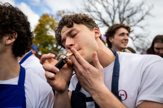 Kyle Barda smokes a cigarette after participating in a Jeremy Allen White lookalike competition at Humboldt Park in Chicago on Nov. 16, 2024. (Tess Crowley/Chicago Tribune)