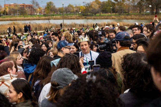 Ben Shabad, center, is crowned winner in a Jeremy Allen White lookalike competition at Humboldt Park in Chicago on Nov. 16, 2024. Shabad won $50 and a pack of cigarettes. (Tess Crowley/Chicago Tribune)