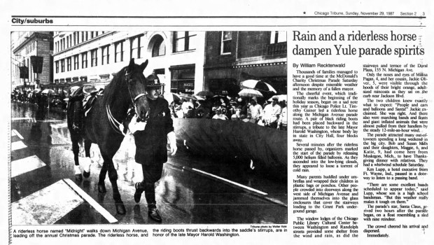 Miserable weather and sadness following the unexpected death of Chicago Mayor Harold Washington lent a somber mood on Nov. 28, 1987, to the McDonald's Charity Christmas Parade on Michigan Avenue. (Chicago Tribune)